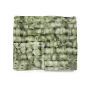 Green textured blanket on a white background