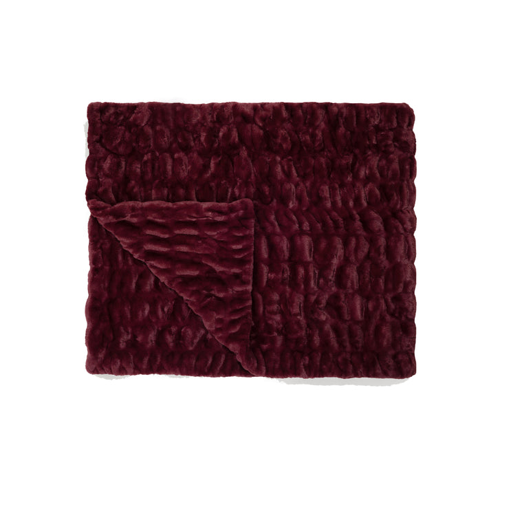 Textured burgundy blanket on a white background