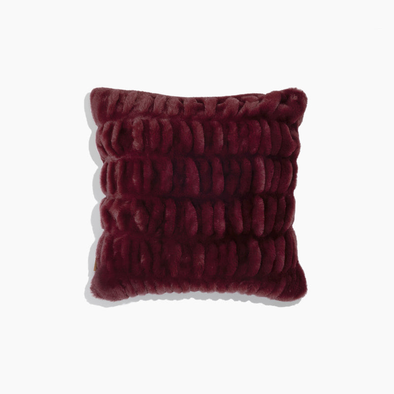 Textured burgundy pillow on a white background