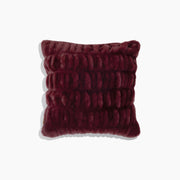 Textured burgundy pillow on a white background