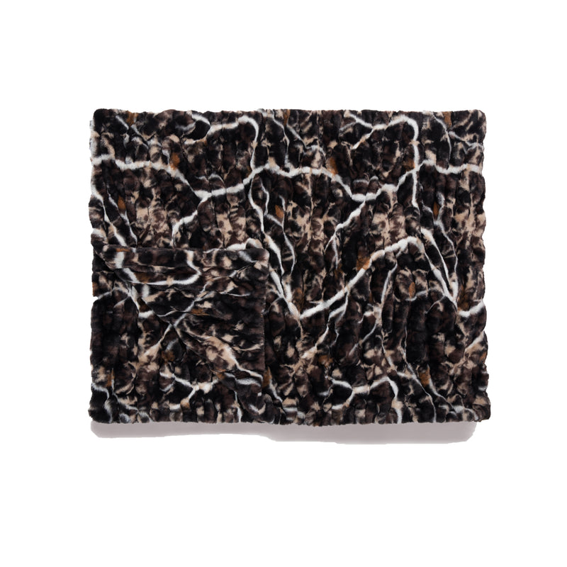 Patterned fabric swatch with a brown and beige design on a white background