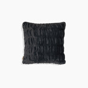 Textured black pillow on a white background