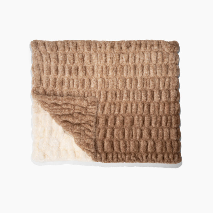 Textured blanket with a gradient from beige to brown on a white background
