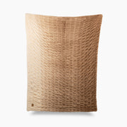 Textured brown pillow on a white background