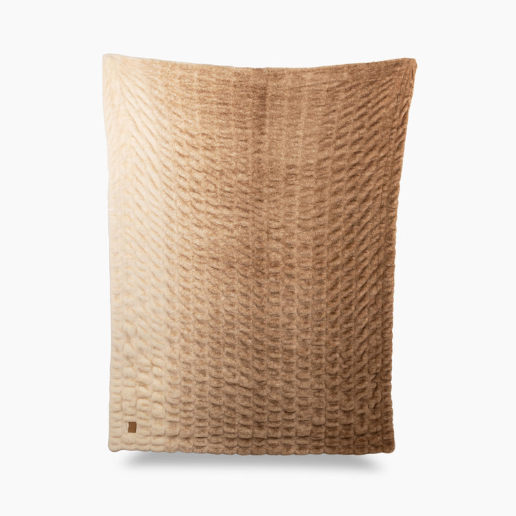 Textured brown pillow on a white background