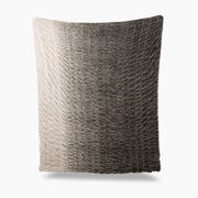 Textured pillow with gradient color from beige to gray on a white background