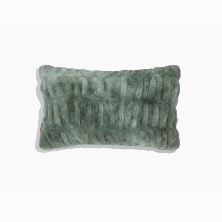 Textured green pillow on a white background