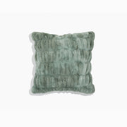 Textured green pillow on a white background