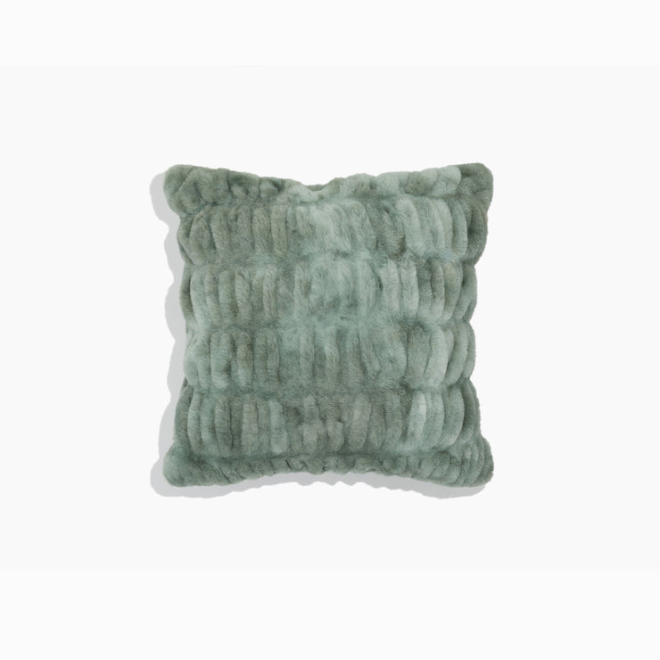 Textured green pillow on a white background