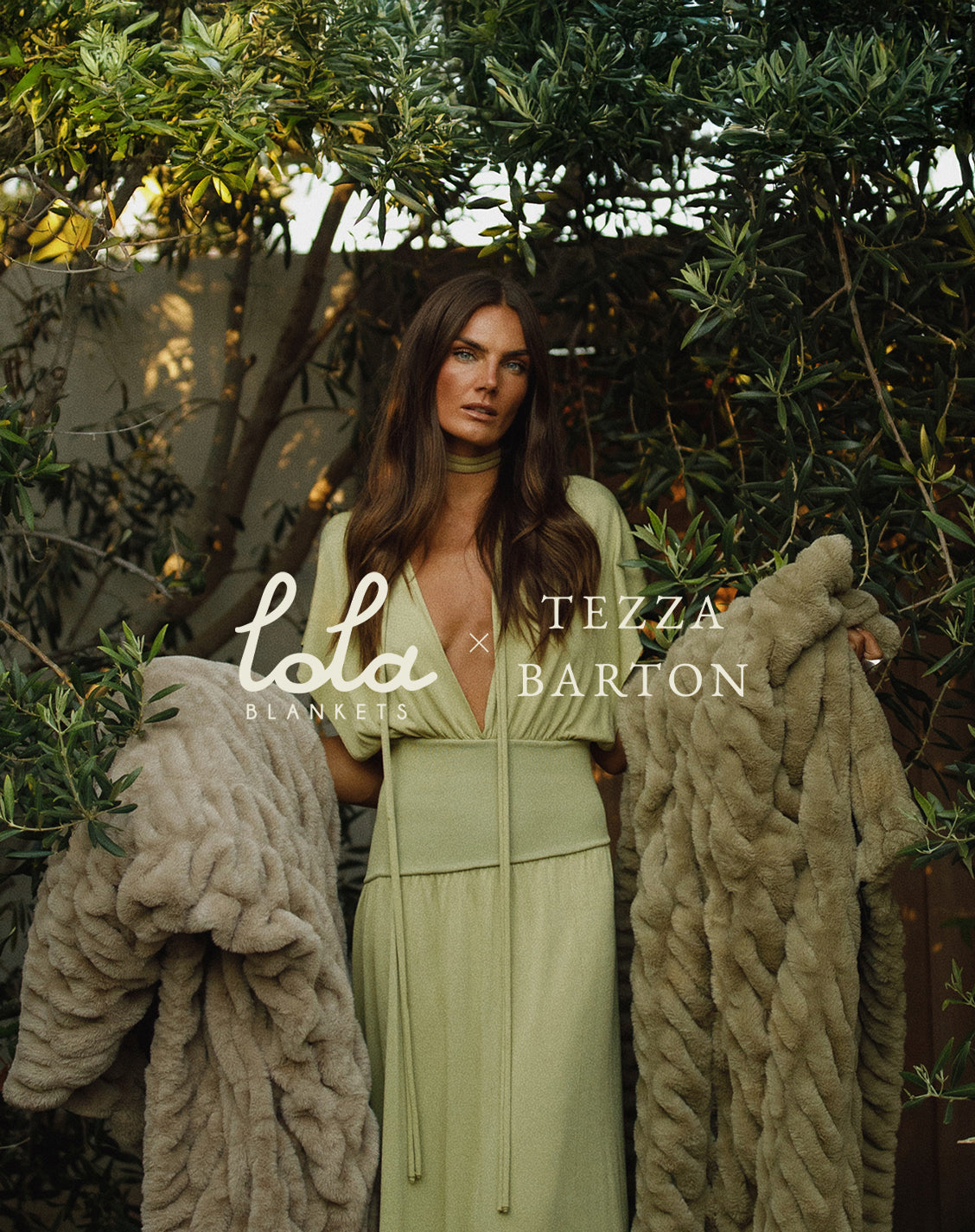 Woman in a green dress holding a blanket with 'Lola Blankets' and 'Tezza Barton' branding.