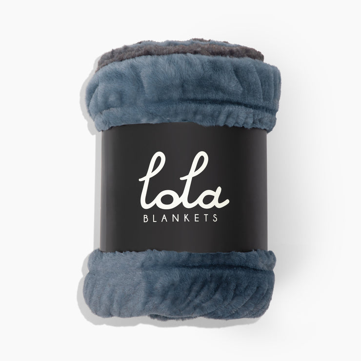 Blue blanket with gray trim on a black label displaying &