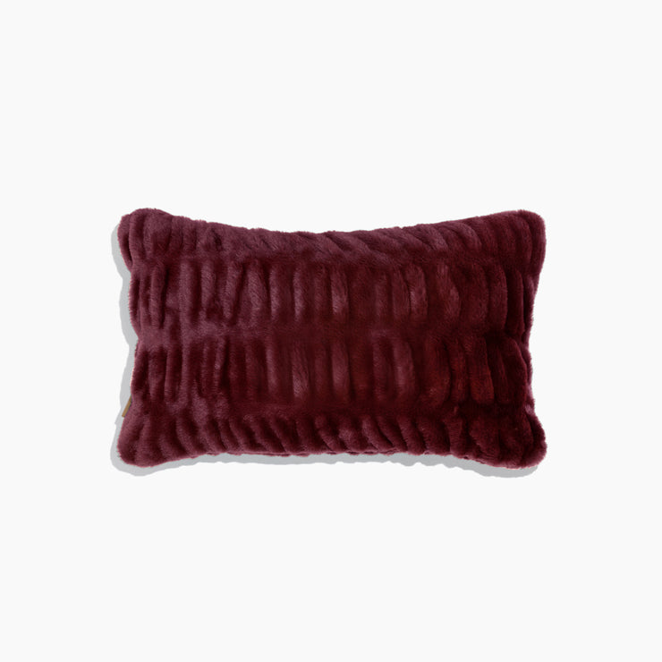 Maroon textured pillow on a white background