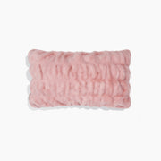 Pink textured pillow on a white background