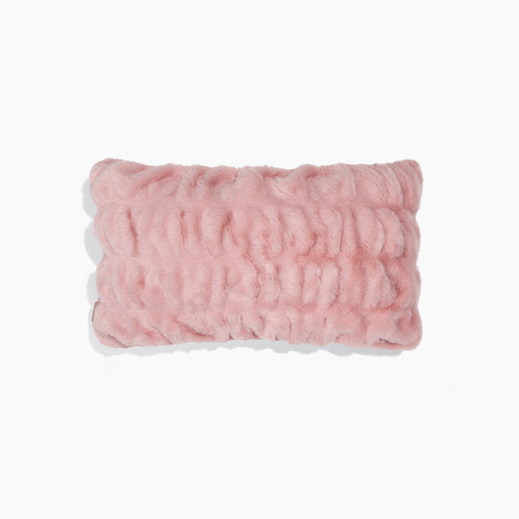 Pink textured pillow on a white background