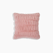 Pink textured pillow on a white background