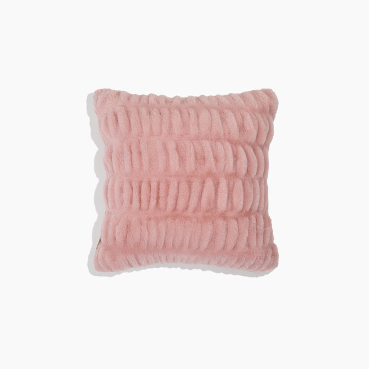 Pink textured pillow on a white background